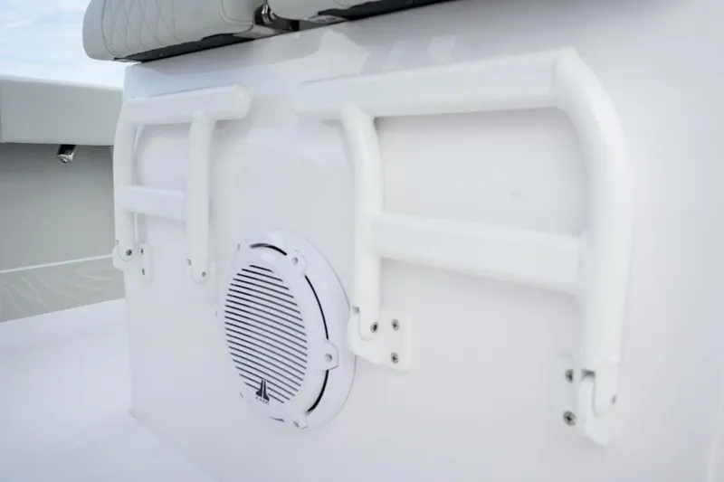 Slide: The Image of 2026 Jupiter 30 boat on trailer outside dealership under clear sky. - 10