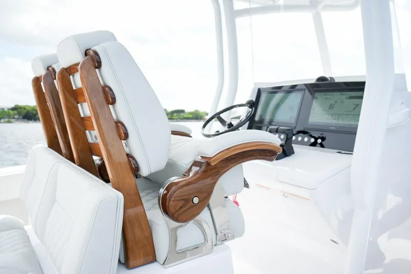 Slide: The Image of 2026 Jupiter 30 boat interior with luxurious seating on a calm water backdrop. - 12