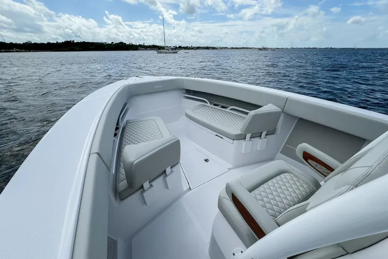 Slide: The Image of Luxury seating on 2026 Jupiter 30 boat with elegant wood and white upholstery. - 19