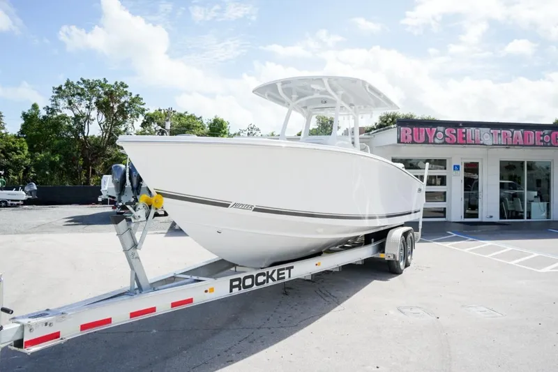 Slide: The Image of 2026 Jupiter 30 boat with dual Yamaha engines on open water. - 2