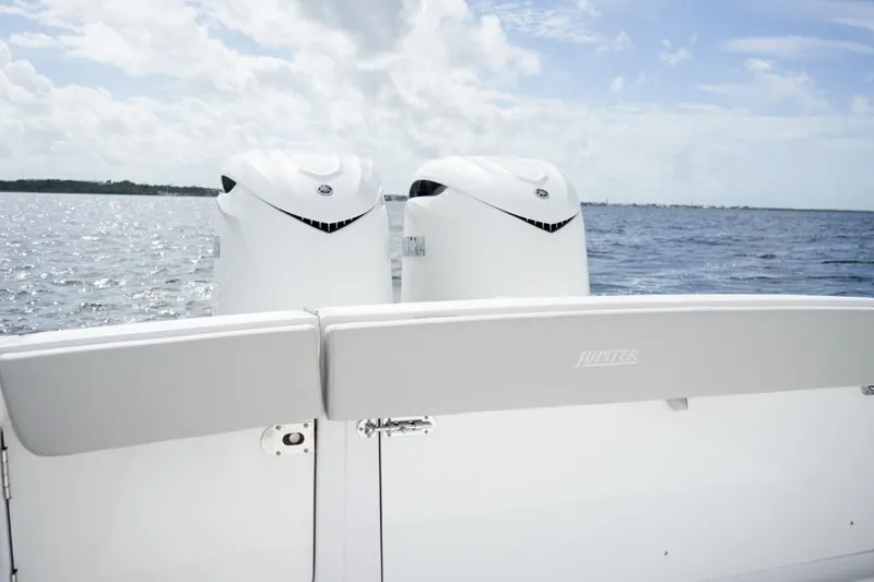 Slide: The Image of Luxurious white leather boat seats with wooden armrests on a 2026 Jupiter 30 model. - 24
