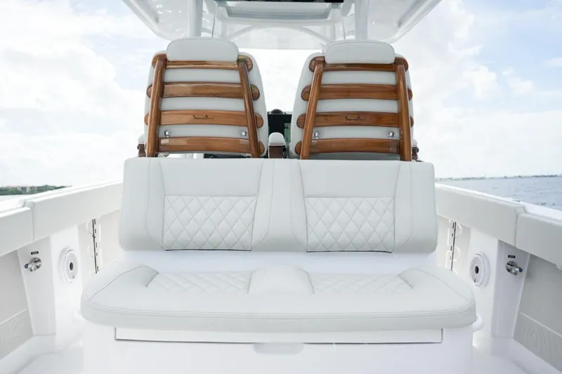 Slide: The Image of Twin outboard motors on a 2026 Jupiter 30 boat navigating through water. - 29