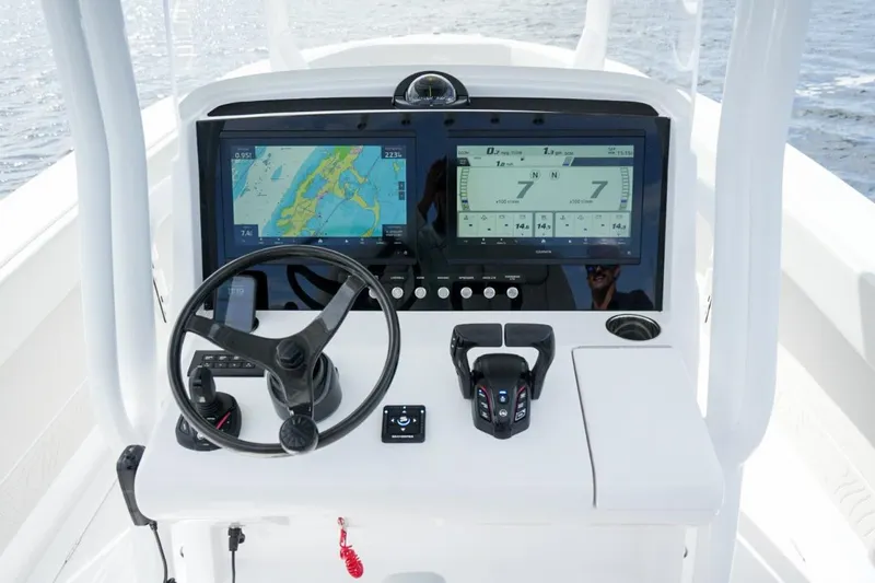 Slide: The Image of Control panel of 2026 Jupiter 30 boat with navigation screens and steering wheel. - 35