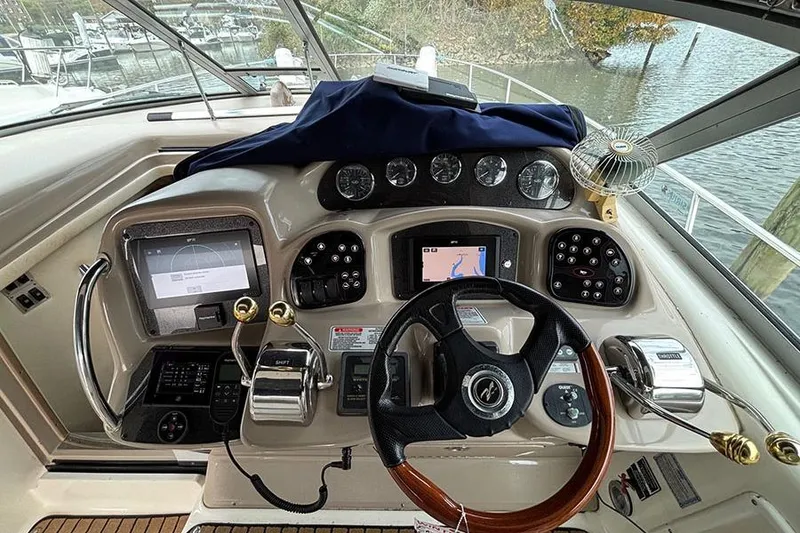 Slide: The Image of Helm of 2005 Sea Ray 340 Sundancer with navigation instruments and steering wheel. - 13