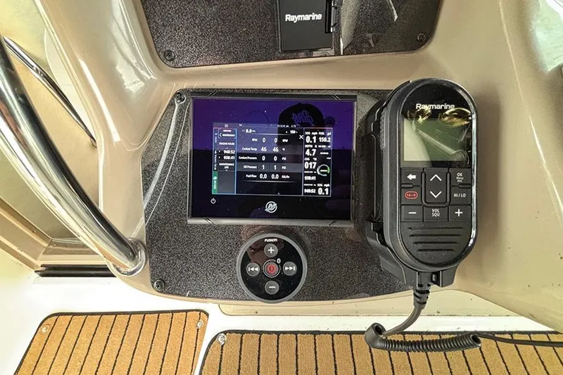 Slide: The Image of Helm of 2005 Sea Ray 340 Sundancer with Raymarine electronics and Fusion audio controls. - 15