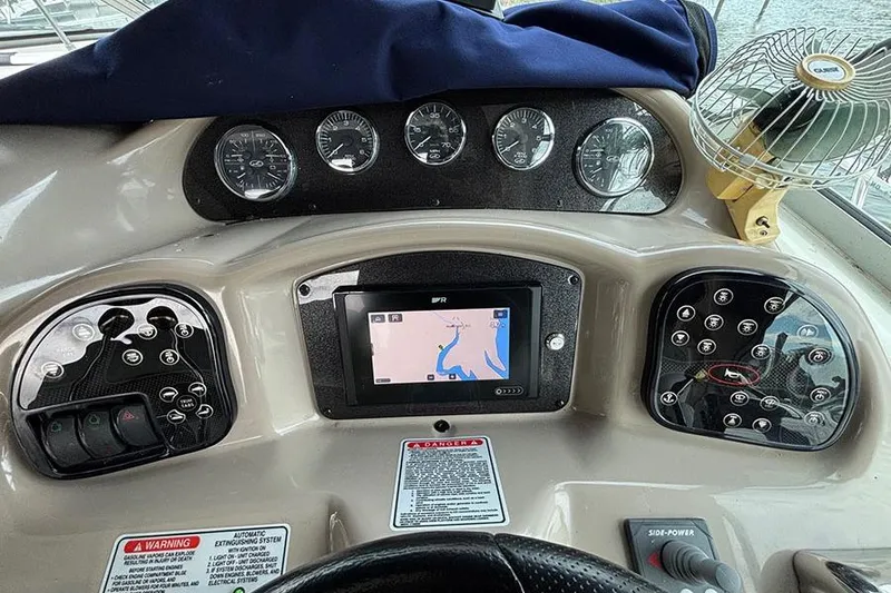 Slide: The Image of Control panel of a 2005 Sea Ray 340 Sundancer boat with navigation display and gauges. - 18