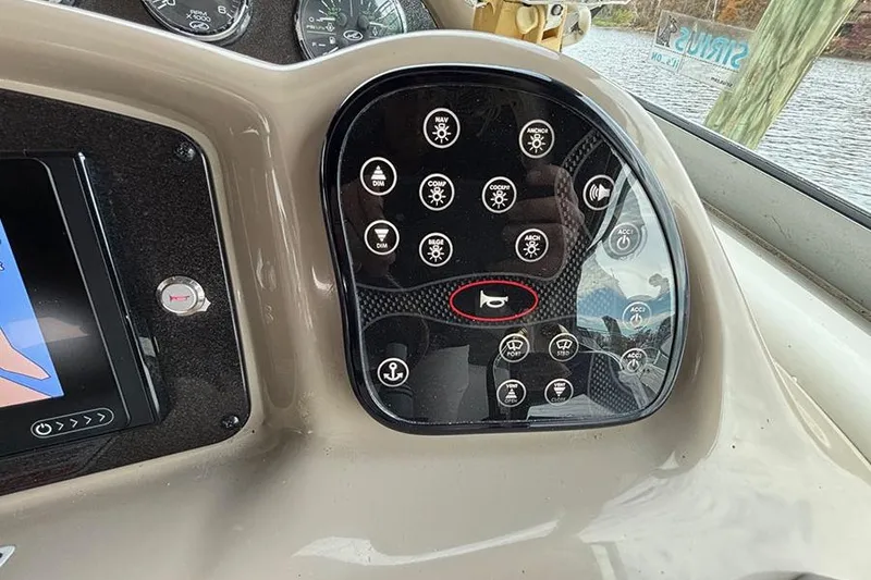 Slide: The Image of Control panel of a 2005 Sea Ray 340 Sundancer boat with various buttons and indicators. - 20