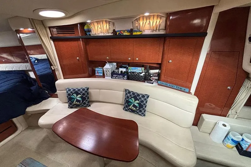 Slide: The Image of Interior of 2005 Sea Ray 340 Sundancer with cozy seating and wooden cabinetry. - 23