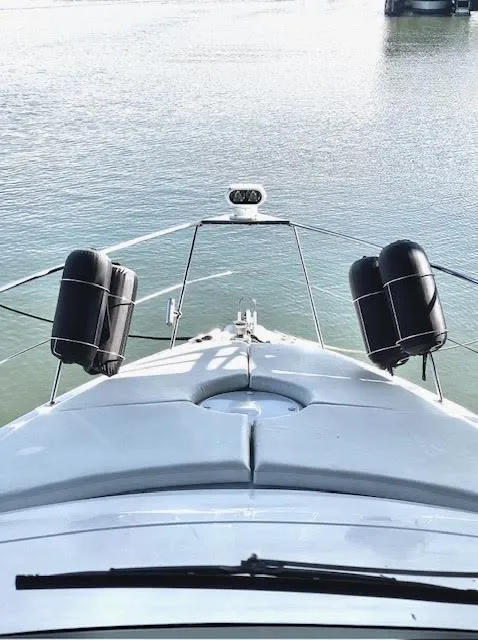 Slide: The Image of 1999 Carver 456 Aft Cabin Motor Yacht bow view on calm water. - 16