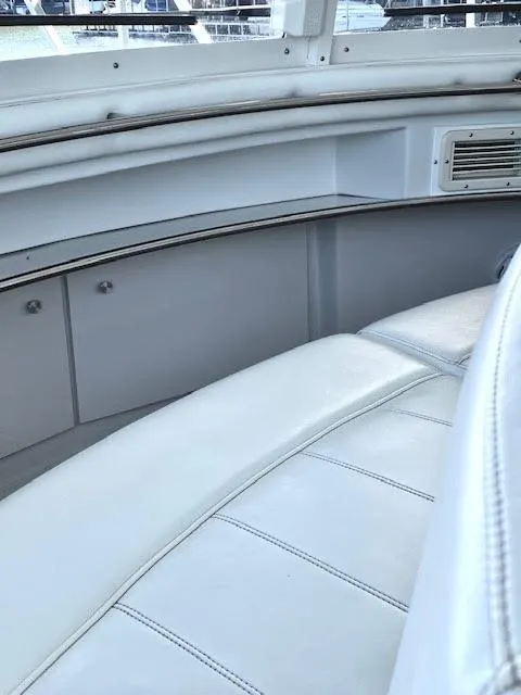 Slide: The Image of 1999 Carver 456 Aft Cabin Motor Yacht interior with white seating and sleek design. - 17
