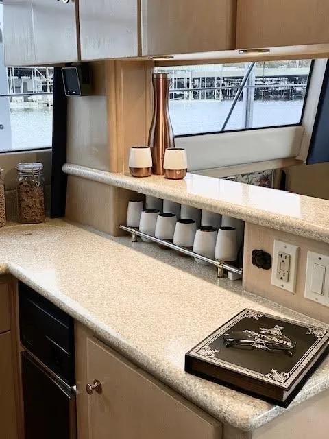 Slide: The Image of 1999 Carver 456 Aft Cabin Motor Yacht interior with modern kitchen and elegant decor. - 23