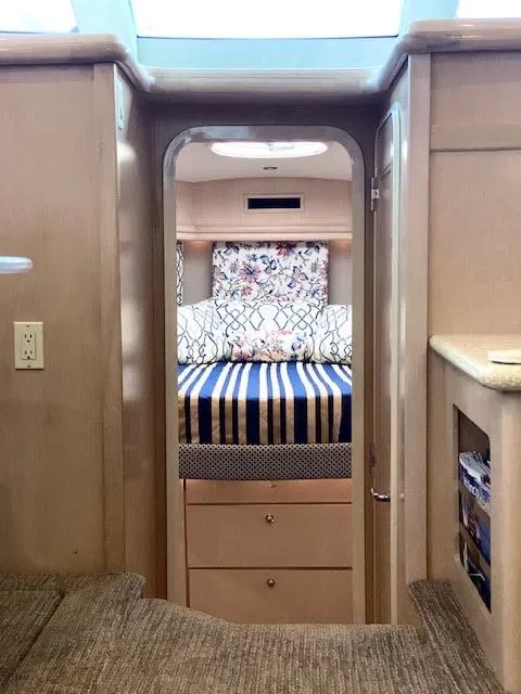 Slide: The Image of Interior of 1999 Carver 456 Aft Cabin Motor Yacht with cozy bedroom view. - 27