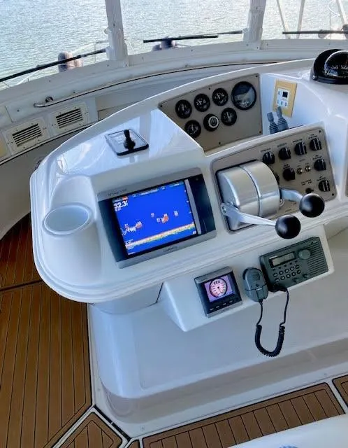Slide: The Image of Helm of 1999 Carver 456 Aft Cabin Motor Yacht with navigation controls and display. - 12