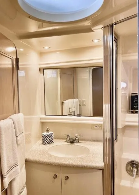 Slide: The Image of 1999 Carver 456 Aft Cabin Motor Yacht bathroom with sink, mirror, and shower. - 30