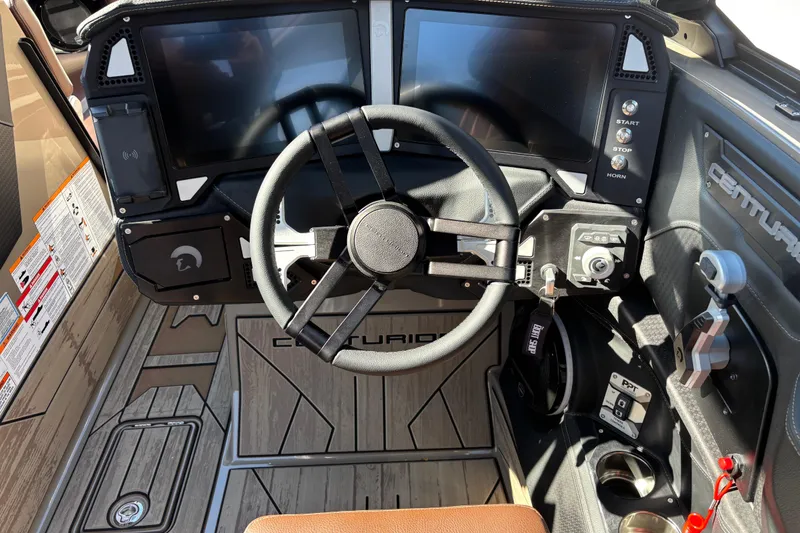 Slide: The Image of 2026 Centurion Ri265 boat dashboard with steering wheel and digital displays. - 10