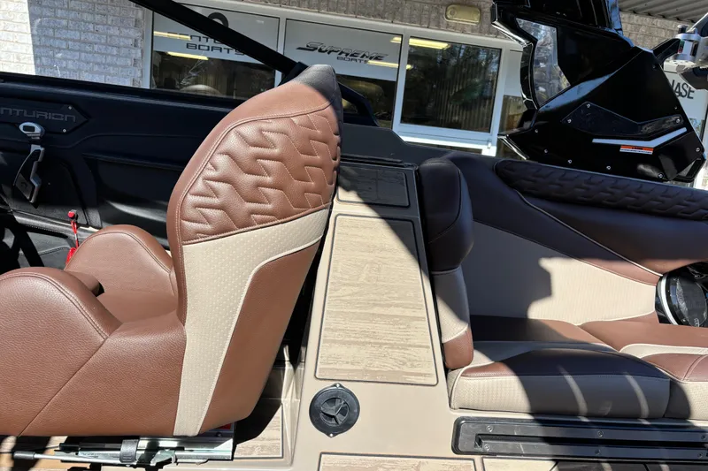 Slide: The Image of 2026 Centurion Ri265 boat interior with brown leather seats and modern design. - 12