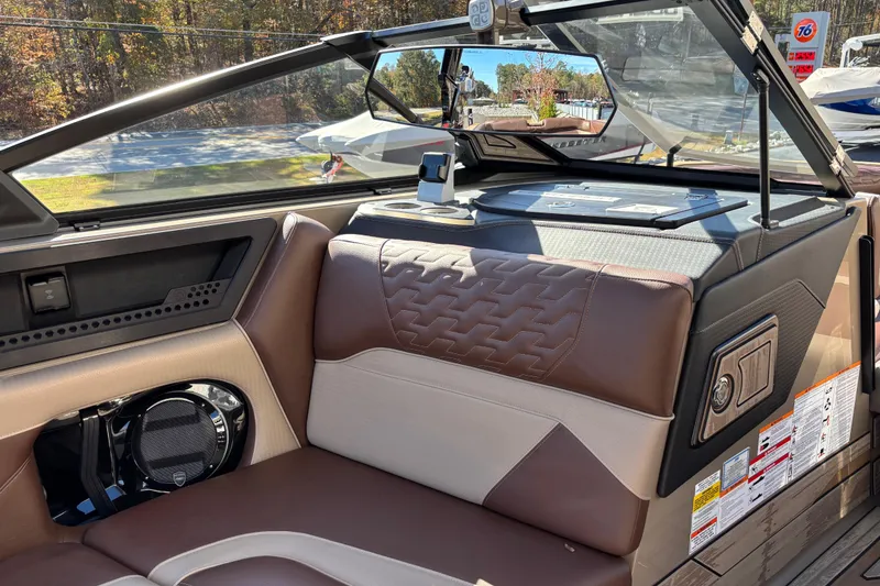 Slide: The Image of 2026 Centurion Ri265 boat interior with brown leather seating and modern dashboard. - 13