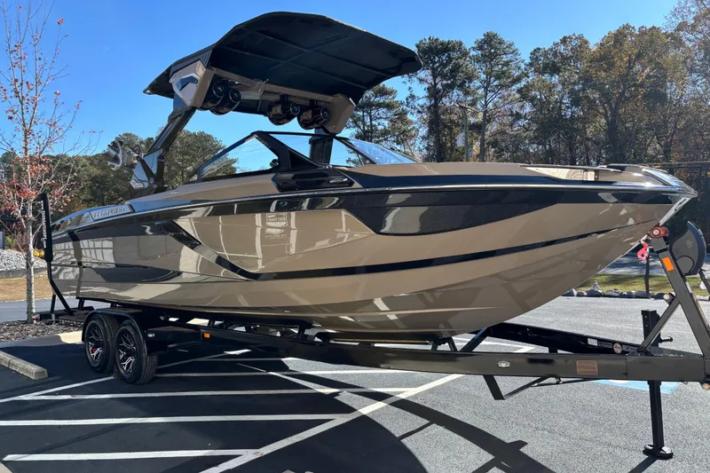 Slide: The Image of 2026 Centurion Ri265 boat on trailer, parked outdoors, showcasing sleek design and modern features. - 3