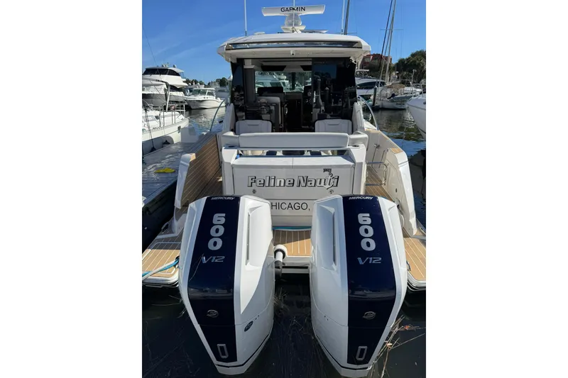 Slide: The Image of 2025 Tiara Yachts 43 LE with dual Mercury 600 V12 engines docked in marina. - 12