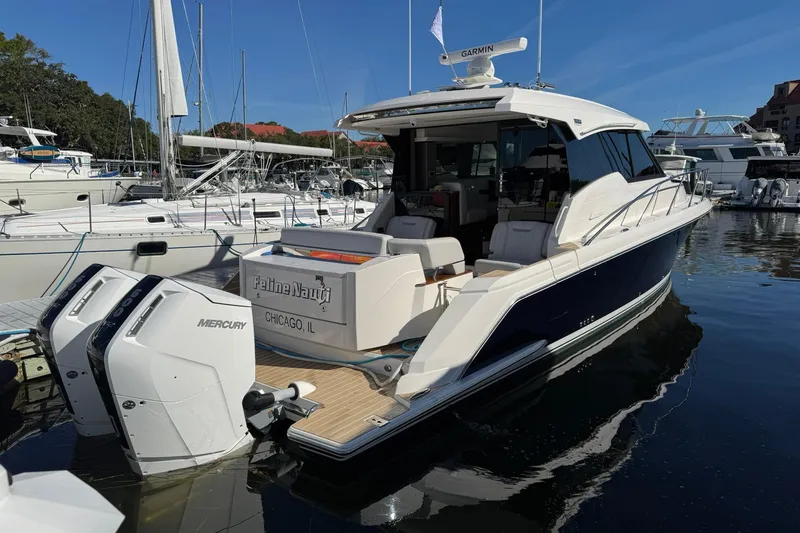 Slide: The Image of 2025 Tiara Yachts 43 LE docked, featuring dual Mercury engines, in a marina setting. - 13