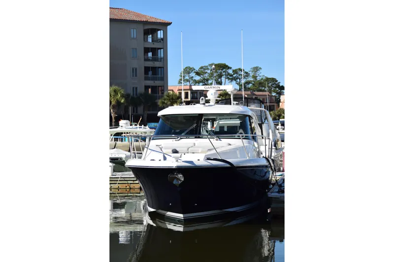 Slide: The Image of 2025 Tiara Yachts 43 LE docked at marina, front view. - 16
