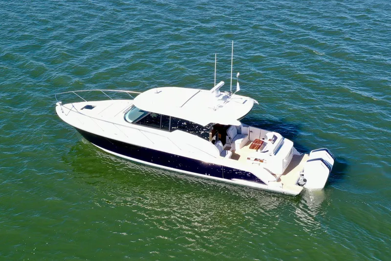 Slide: The Image of 2025 Tiara Yachts 43 LE cruising on open water, showcasing sleek design and luxury features. - 2