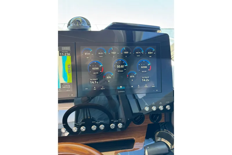 Slide: The Image of Dashboard of 2025 Tiara Yachts 43 LE with Garmin display showing navigation and engine data. - 22