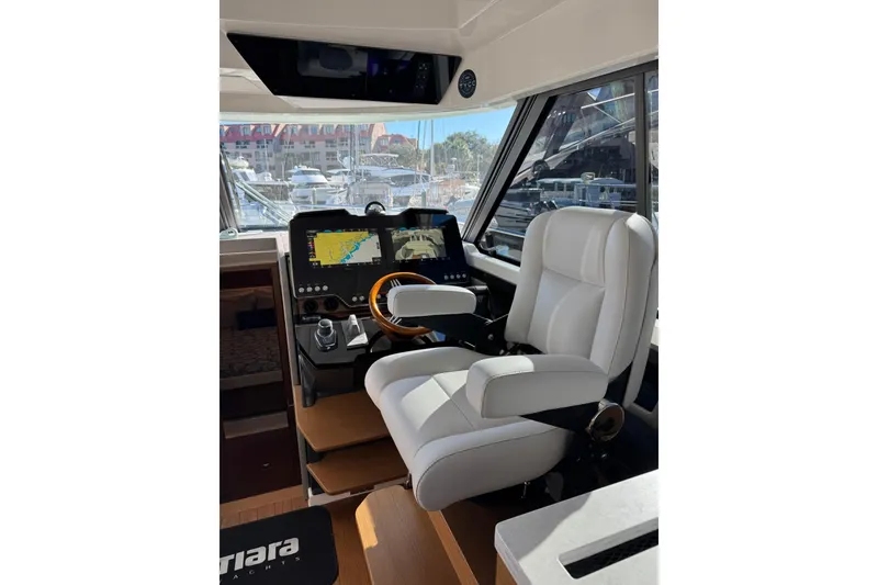 Slide: The Image of Helm of 2025 Tiara Yachts 43 LE with modern navigation displays and luxurious seating. - 29