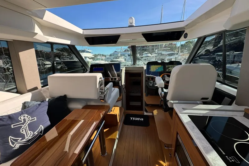 Slide: The Image of Interior of 2025 Tiara Yachts 43 LE, featuring modern helm and luxurious seating. - 36