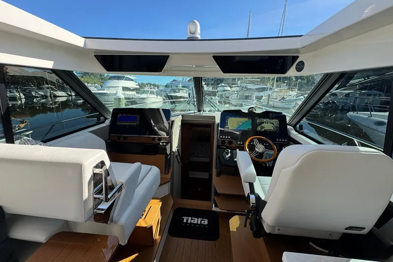 Slide: The Image of Interior of 2025 Tiara Yachts 43 LE, featuring modern navigation systems and luxurious seating. - 39