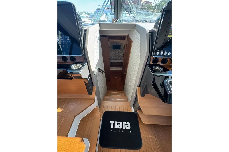 Slide: The Image of Interior view of 2025 Tiara Yachts 43 LE, featuring sleek wooden stairs and modern design. - 42