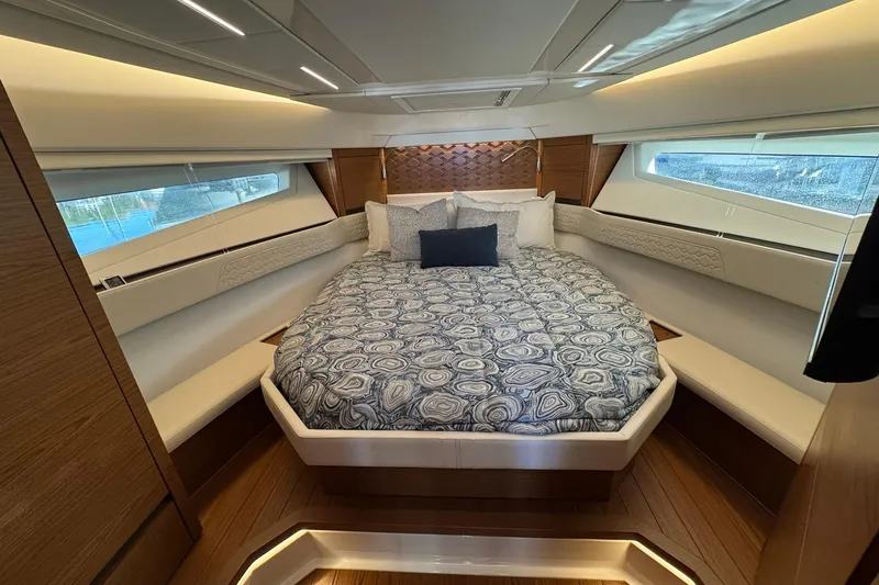 Slide: The Image of Luxurious 2025 Tiara Yachts 43 LE cabin interior with elegant bedding and modern design. - 44