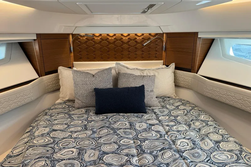 Slide: The Image of Luxurious cabin interior of 2025 Tiara Yachts 43 LE with elegant bedding and wood accents. - 45