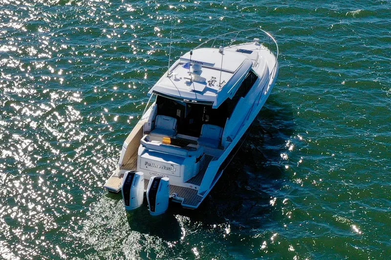 Slide: The Image of 2025 Tiara Yachts 43 LE cruising on sparkling water, aerial view. - 5