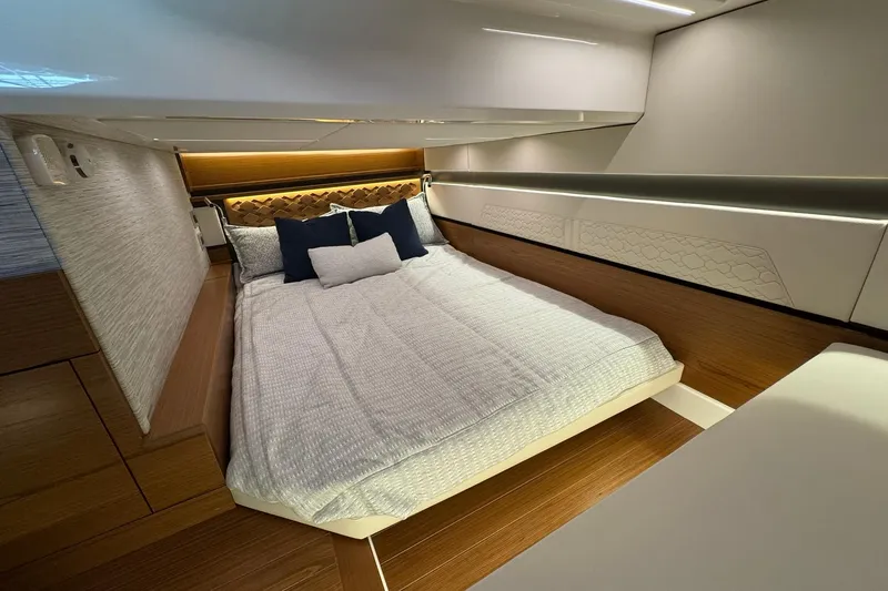 Slide: The Image of Luxurious bedroom interior of 2025 Tiara Yachts 43 LE with modern design and cozy bedding. - 51