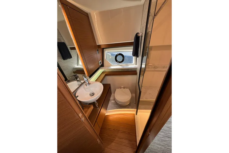 Slide: The Image of Luxurious bathroom in 2025 Tiara Yachts 43 LE, featuring modern fixtures and elegant wood finishes. - 55