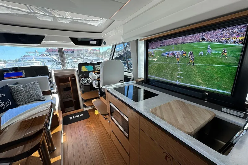 Slide: The Image of Luxurious interior of 2025 Tiara Yachts 43 LE with modern amenities and large TV screen. - 58
