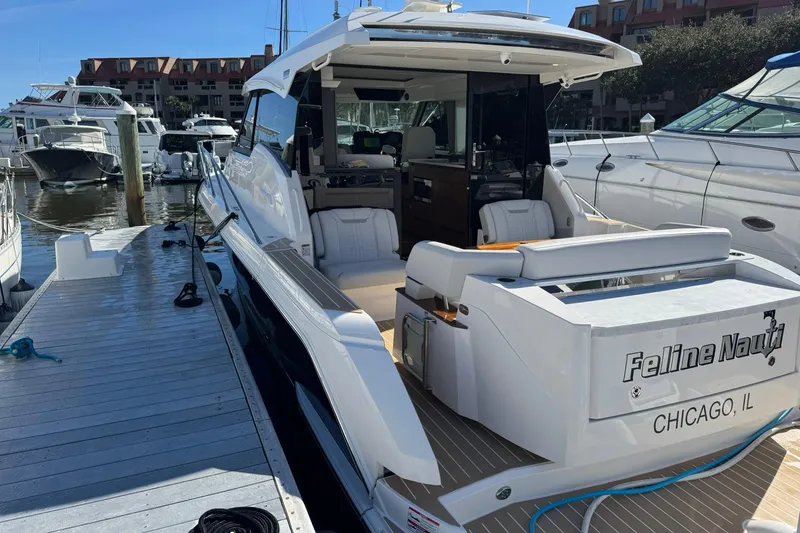 Slide: The Image of 2025 Tiara Yachts 43 LE docked, featuring sleek design and luxurious seating. - 67