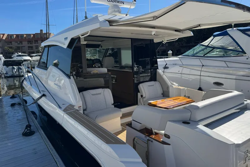 Slide: The Image of 2025 Tiara Yachts 43 LE luxury yacht docked, featuring elegant seating and modern design. - 68