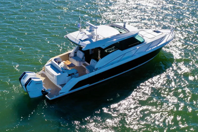 Slide: The Image of 2025 Tiara Yachts 43 LE cruising on sparkling water, showcasing sleek design and powerful engines. - 7