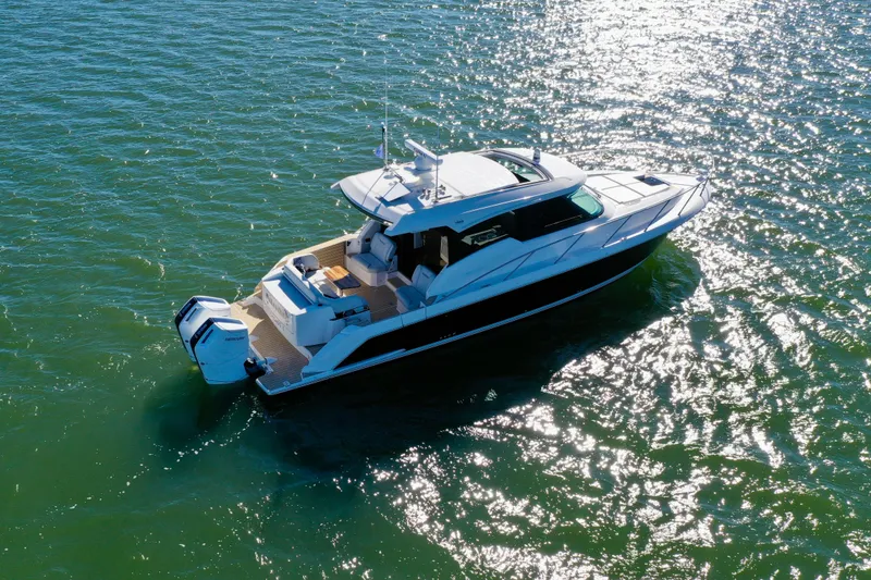 Slide: The Image of 2025 Tiara Yachts 43 LE cruising on sparkling water. - 8