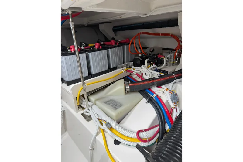 Slide: The Image of Engine compartment of 2025 Tiara Yachts 43 LE, showcasing batteries and wiring. - 82
