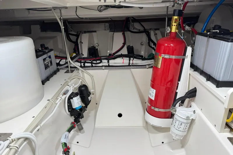 Slide: The Image of Engine room of 2025 Tiara Yachts 43 LE with fire extinguisher and batteries. - 83