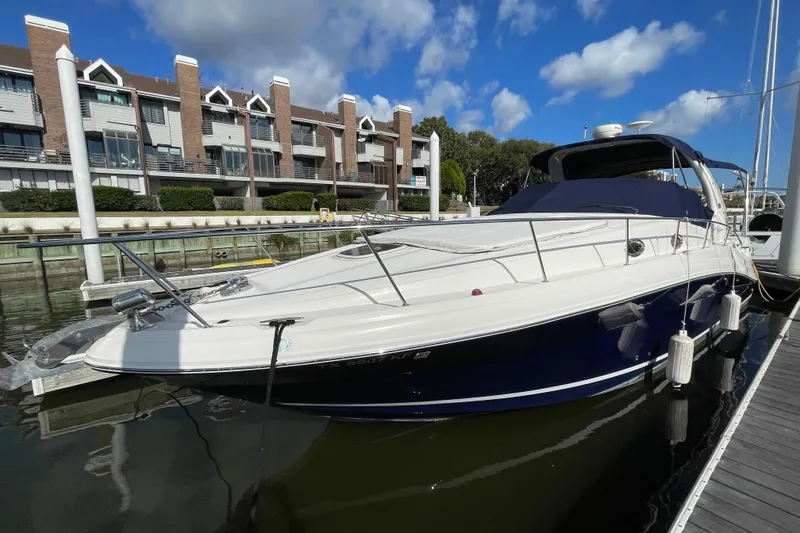 Slide: The Image of 2005 Sea Ray 340 Sundancer yacht interior with seating and table, docked at marina. - 10