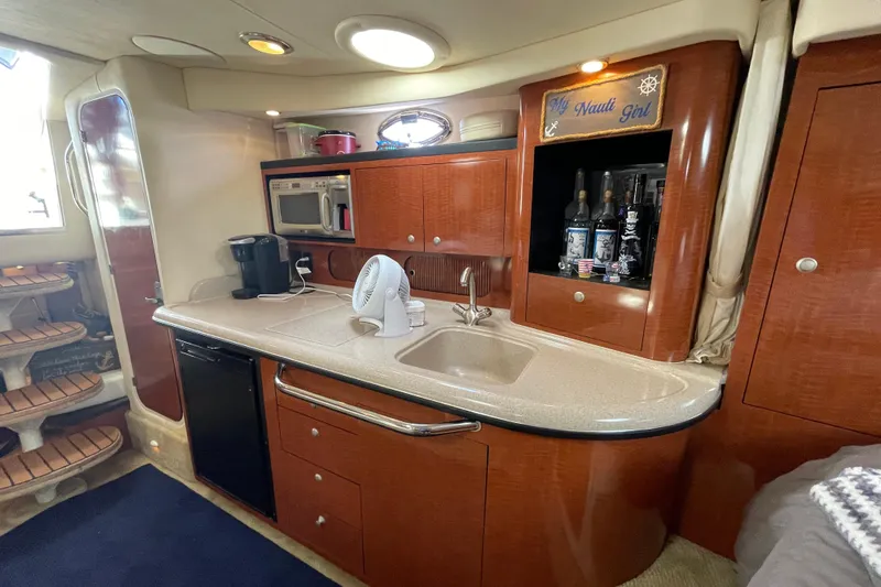 Slide: The Image of 2005 Sea Ray 340 Sundancer yacht kitchen with sink, microwave, and coffee maker. - 25