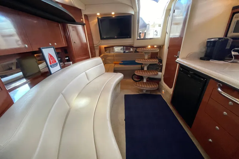Slide: The Image of Interior of 2005 Sea Ray 340 Sundancer with cozy bed and wooden cabinetry. - 26