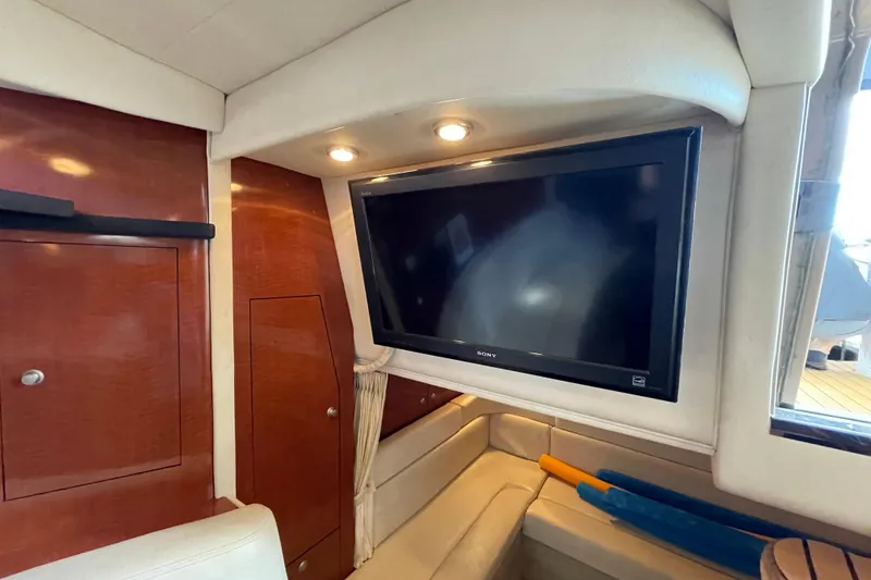 Slide: The Image of Luxurious interior of 2005 Sea Ray 340 Sundancer with elegant seating and wooden cabinetry. - 28