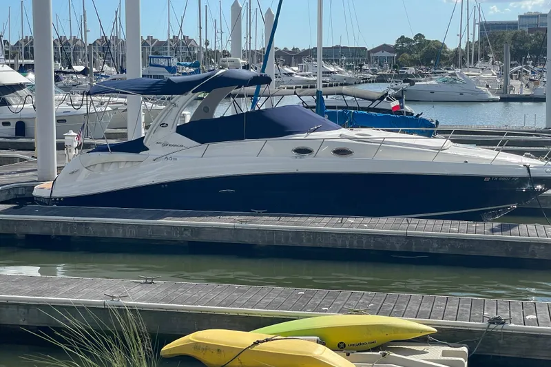 Slide: The Image of 2005 Sea Ray 340 Sundancer docked at marina under blue sky. - 3