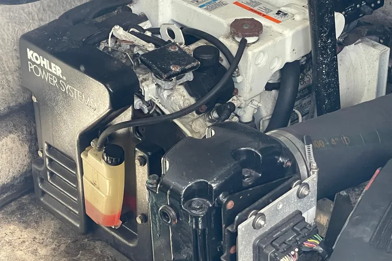 Slide: The Image of Interior of 2005 Sea Ray 340 Sundancer yacht with white seating and wooden cabinetry. - 30