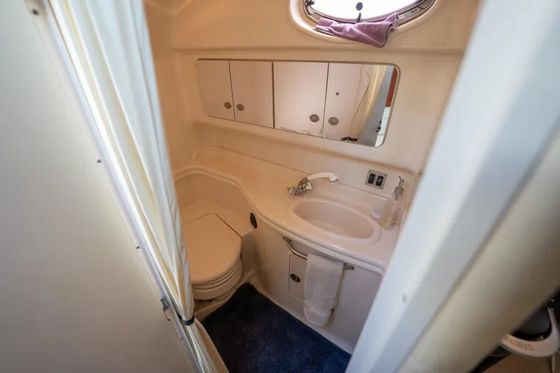 Slide: The Image of 2005 Sea Ray 340 Sundancer bathroom with sink, mirror, and toilet. - 32